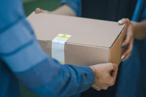 person giving brown box
