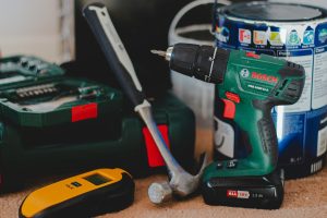 red and black cordless power drill beside black and red cordless power drill